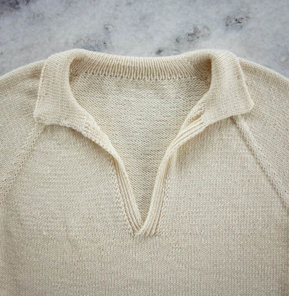 Polo Sweater neckline detail image showing the polo collar, raglans, and neckline
