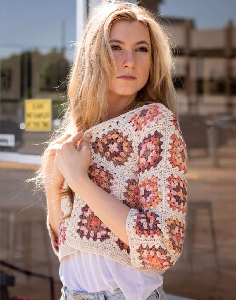 Granny Square Cardigan main image, model wearing the cardigan standing slightly to the side and looking over her shoulder