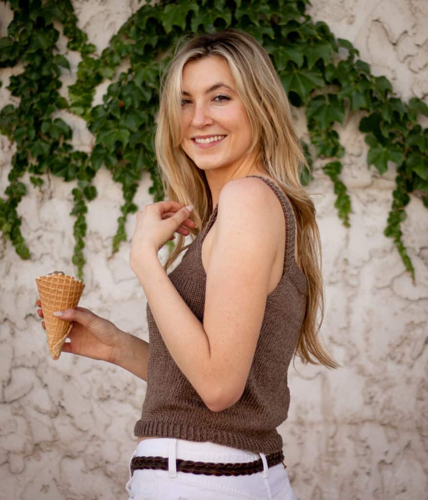 simple summer tank top knitting pattern worn on woman standing to the side holding ice cream cone